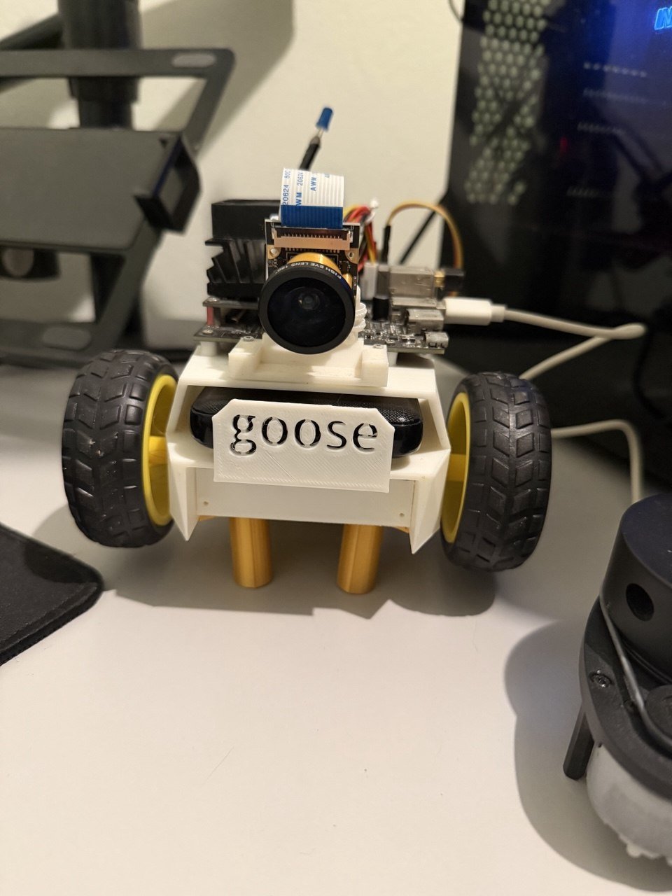 JetBot from the front, with a 3D-printed nameplate reading