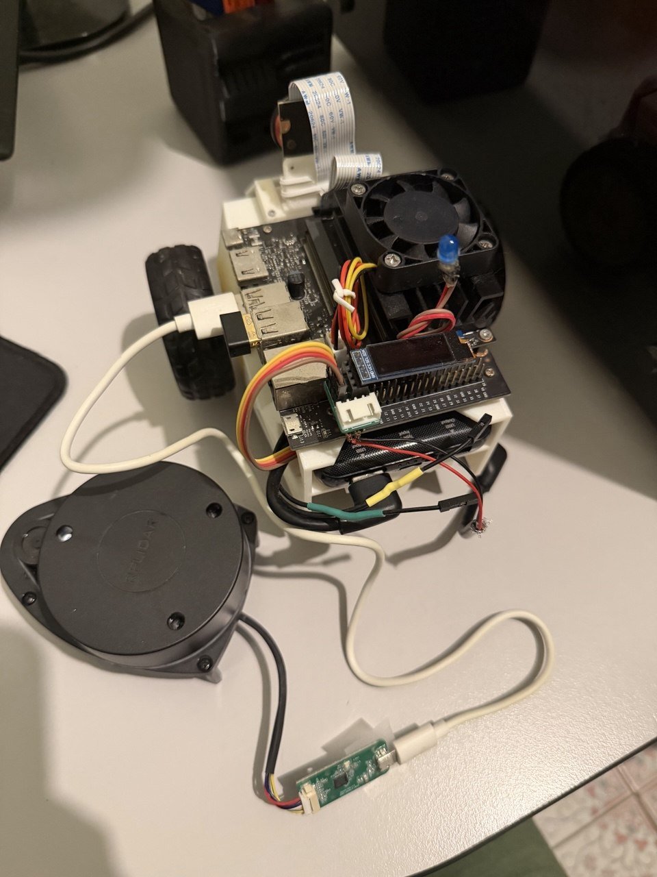 JetBot from above, showing the wiring and OLED display, beside an RPLIDAR sensor